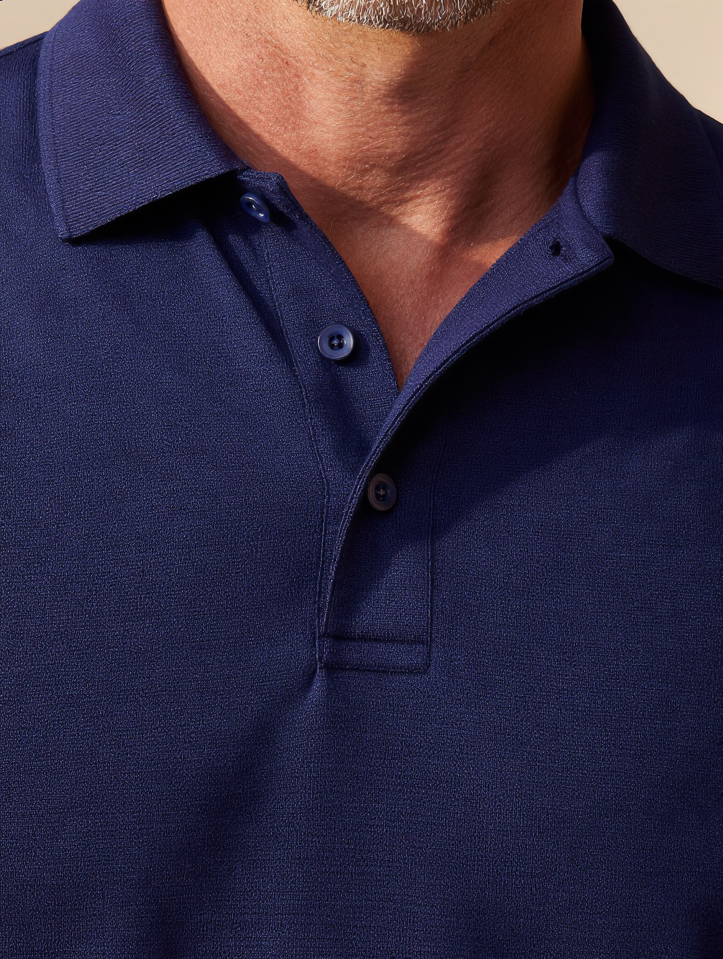 Close-up of the navy Uniform Polo collar and knit