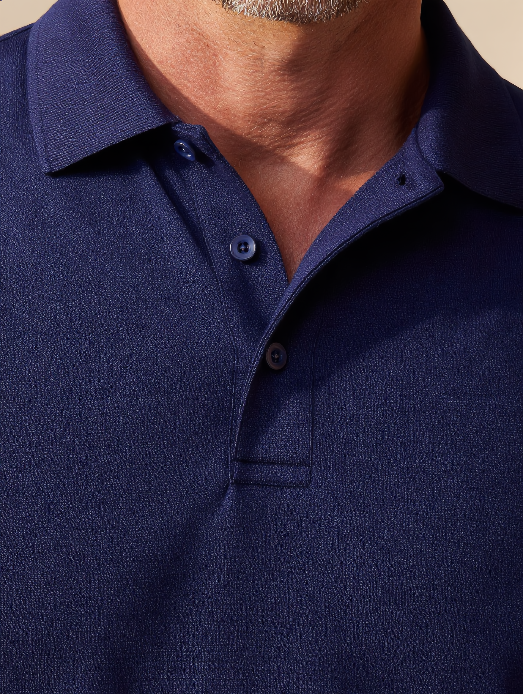 Close-up of the navy Uniform Polo collar and knit